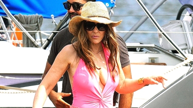 Elizabeth Hurley Rocks Neon Pink Halter Swimsuit On Elton John’s Yacht In France